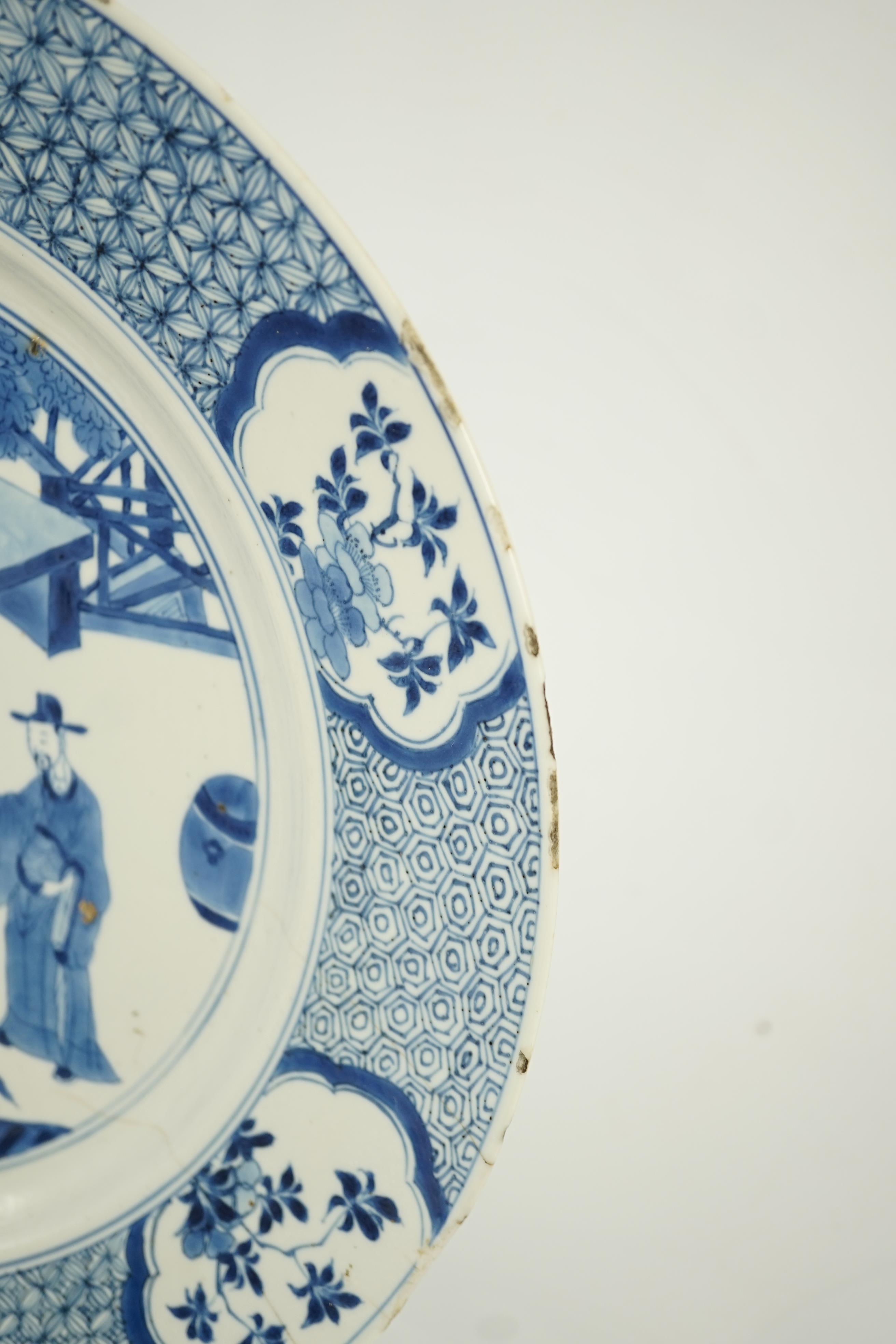 A Chinese blue and white ‘court scene’ dish, Kangxi period, two rim cracks and small splinter chips